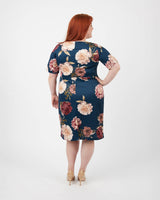 Woman wearing a floral dress on a white background. This dress is the Rivermont Dress & Top sewing pattern from Cashmerette.