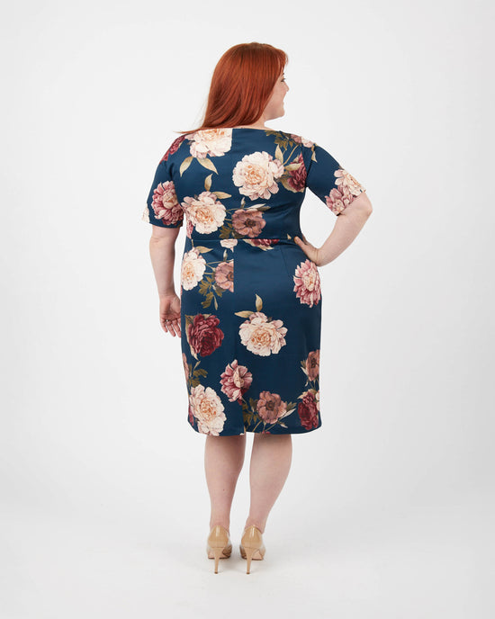Woman wearing a floral dress on a white background. This dress is the Rivermont Dress & Top sewing pattern from Cashmerette.