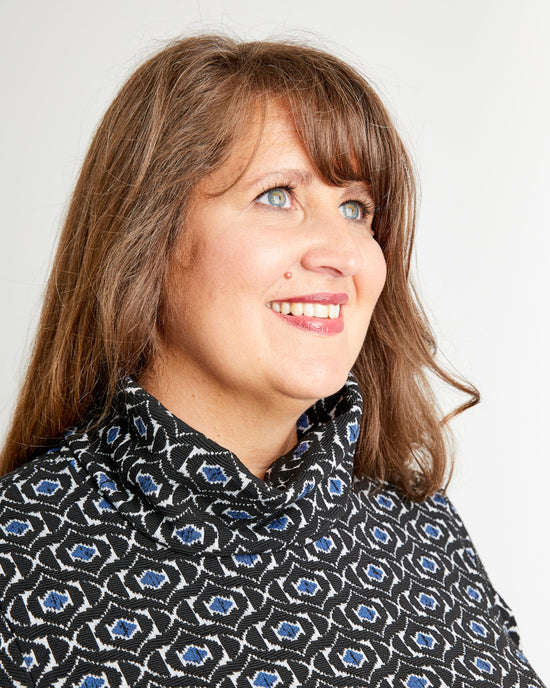 Woman wearing a patterned sweater against a plain background. This is the Pembroke Dress & Tunic sewing pattern from Cashmerette.