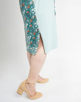 Person wearing a floral skirt and beige sandals on a white background. This is the Pembroke Dress & Tunic sewing pattern from Cashmerette.