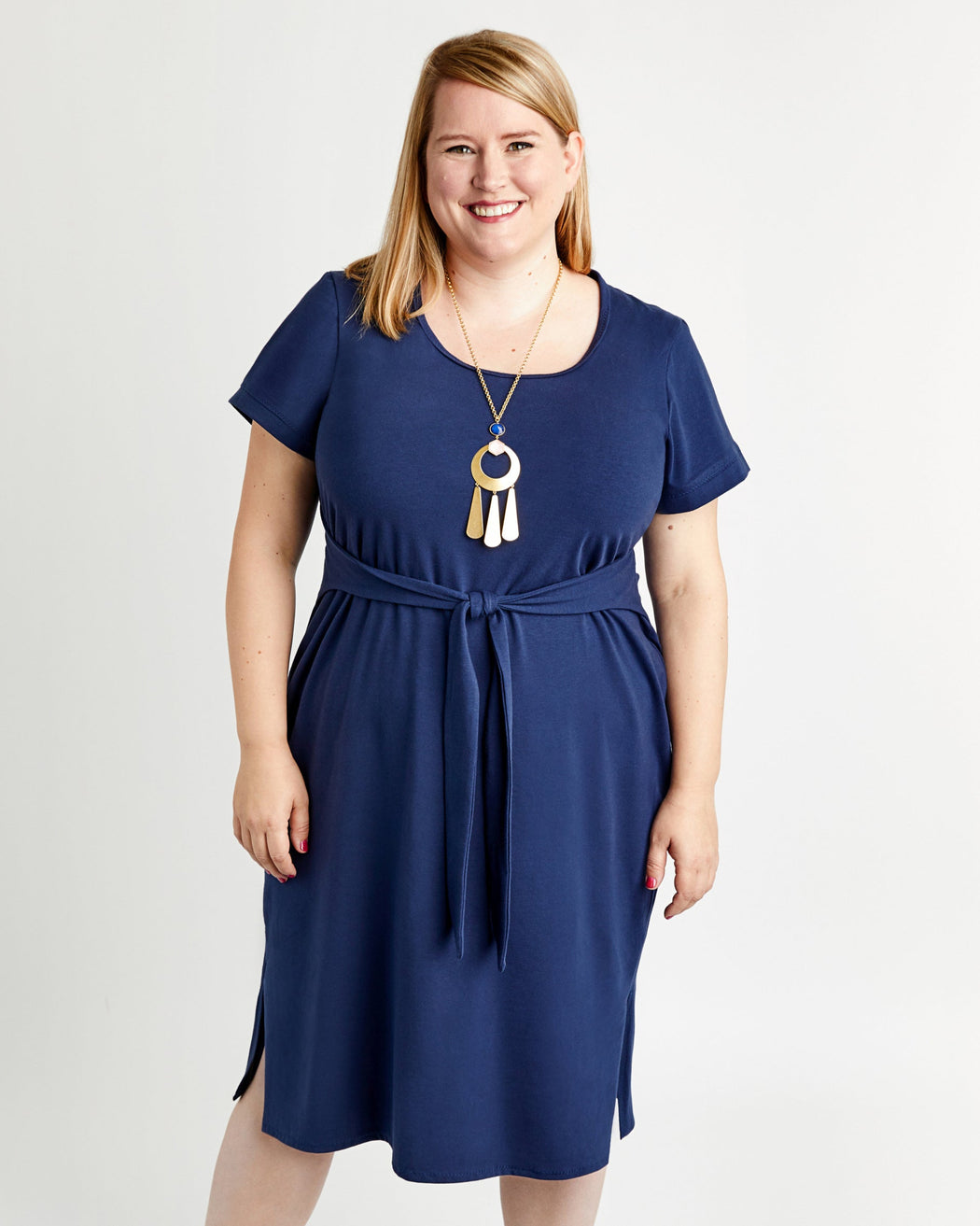 Woman wearing a blue dress with a white background. This is the Pembroke Dress & Tunic sewing pattern from Cashmerette.