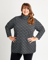 Woman wearing a patterned jacket against a plain background. This is the Pembroke Dress & Tunic sewing pattern from Cashmerette.