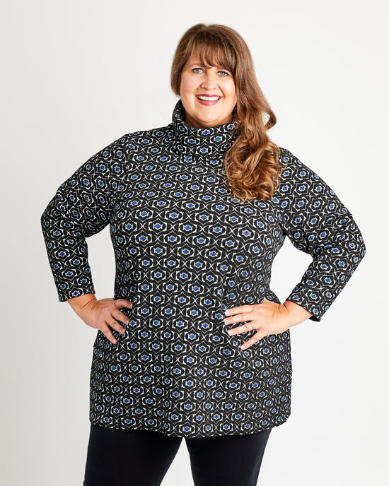 Woman wearing a patterned jacket against a plain background. This is the Pembroke Dress & Tunic sewing pattern from Cashmerette.