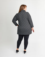 Woman wearing a patterned coat on a white background. This is the Pembroke Dress & Tunic sewing pattern from Cashmerette.
