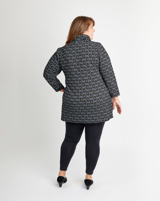 Woman wearing a patterned coat on a white background. This is the Pembroke Dress & Tunic sewing pattern from Cashmerette.