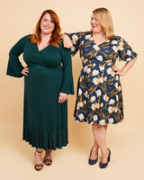 Two women wearing green and floral dresses on a beige background. This dress is the Alcott Dress sewing pattern from Cashmerette.