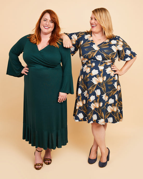 Two women wearing green and floral dresses on a beige background. This dress is the Alcott Dress sewing pattern from Cashmerette.