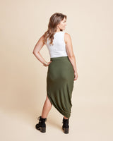 Woman wearing a white top and green skirt on a beige background. This is the Grafton Dress, Top & Skirt sewing pattern from Cashmrette.
