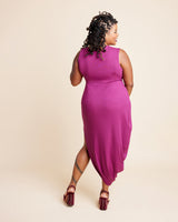 Woman wearing a magenta sleeveless dress on a beige background. This is the Grafton Dress, Top & Skirt sewing pattern from Cashmerette.