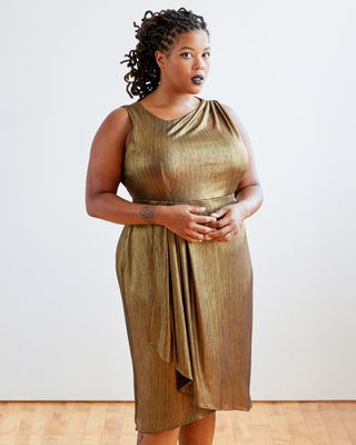 Woman wearing a gold dress against a white background. This dress is the Dewey Dress sewing pattern from Cashmerette.