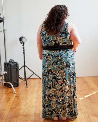 Person wearing a floral dress in a studio setting with photography equipment. This dress is the Dewey Dress sewing pattern from Cashmerette.