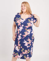 Woman wearing a floral dress on a white background. This is the nursing expansion pack sewing pattern from Cashmerette.