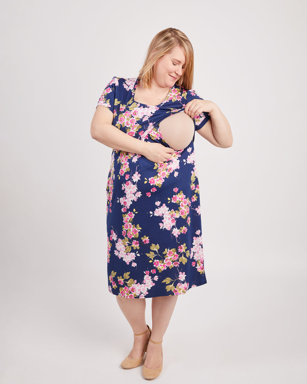 Woman wearing a floral dress with a white background. This is the nursing expansion pack sewing pattern from Cashmerette.