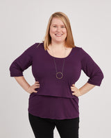 Woman wearing a purple shirt with a plain background. This is the nursing expansion pack sewing pattern from Cashmerette.