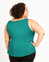 Woman wearing a teal sleeveless top on a white background. This top is the Springfield Top sewing pattern from Cashmerette.