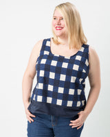 Woman wearing a blue and white checkered tank top against a white background. This top is the Springfield Top sewing pattern from Cashmerette.