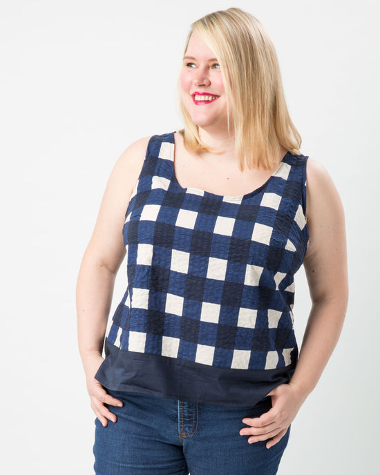 Woman wearing a blue and white checkered tank top against a white background. This top is the Springfield Top sewing pattern from Cashmerette.