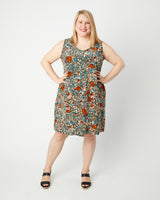 Woman wearing a floral dress on a white background. This dress is the Webster Dress & Tunic sewing pattern from Cashmerette.