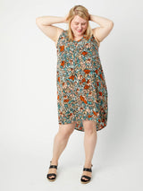 Woman wearing a floral dress on a white background. This dress is the Webster Dress & Tunic sewing pattern from Cashmerette.