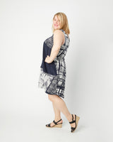 Woman wearing a sleeveless dress with a geometric pattern on a white background. This top is the Webster Dress & Tunic sewing pattern from Cashmerette.