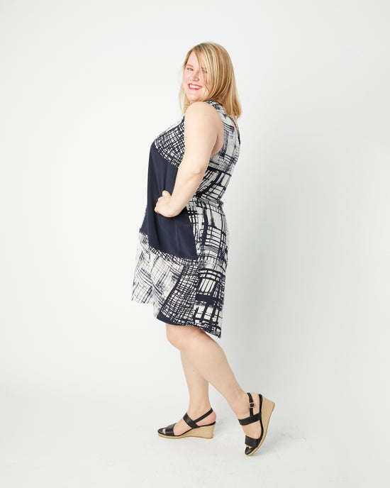 Woman wearing a sleeveless dress with a geometric pattern on a white background. This top is the Webster Dress & Tunic sewing pattern from Cashmerette.