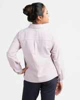 Woman wearing a light purple jacket on a white background. This top is the Vernon Shirt sewing pattern from Cashmerette.