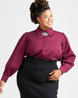 Woman wearing a burgundy blouse with a decorative collar against a white background. This top is the Vernon Shirt sewing pattern from Cashmerette.