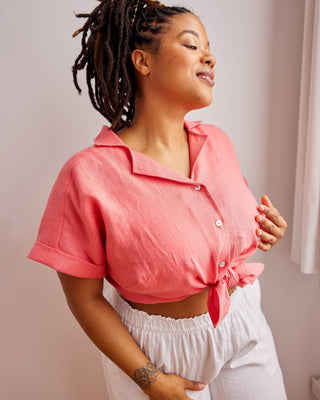 Woman wearing a pink cropped shirt and white pants against a neutral background. Woman wearing a plaid shirt and denim shorts against a neutral background. This top is the Haskell Shirt sewing pattern from Cashmerette.