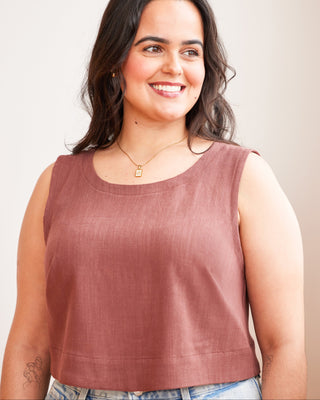Woman wearing a brown sleeveless top against a plain background. This top is the Thorndike Tank sewing pattern from Cashmerette.