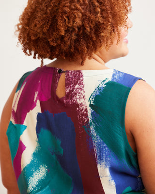 Person wearing a colorful sleeveless top with abstract patterns on a plain background. This top is the Thorndike Tank sewing pattern from Cashmerette.