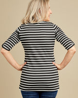 Woman wearing a black and white striped shirt against a beige background. This t-shirt is the Concord T-Shirt sewing pattern from Cashmerette.