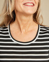 Close-up of a person wearing a black and white striped shirt. This t-shirt is the Concord T-Shirt sewing pattern from Cashmerette.