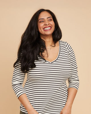 Woman wearing a black and white striped shirt against a beige backgroundThis t-shirt is the Concord T-Shirt sewing pattern from Cashmerette.