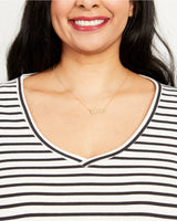 Woman wearing a gold necklace with a white and black striped shirt. This t-shirt is the Concord T-Shirt sewing pattern from Cashmerette.