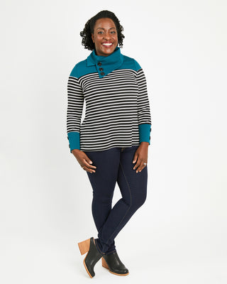 Woman wearing a striped sweater with teal accents on a white background. This sweater is the Tobin Sweater sewing pattern from Cashmerette.