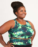 Woman wearing a green leaf-patterned top against a white background. This tank top is the Saybrook Tank sewing pattern from Cashmerette.