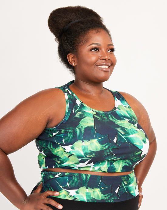 Woman wearing a green leaf-patterned top against a white background. This tank top is the Saybrook Tank sewing pattern from Cashmerette.