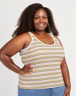 Woman wearing a striped tank top against a plain background. This tank top is the Saybrook Tank sewing pattern from Cashmerette.