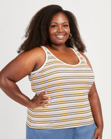 Woman wearing a striped tank top against a plain background. This tank top is the Saybrook Tank sewing pattern from Cashmerette.