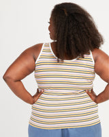 Woman wearing a striped tank top with her hands on her hips against a white background. This tank top is the Saybrook Tank sewing pattern from Cashmerette.