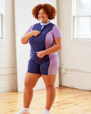 Person wearing a colorful athletic outfit in a bright room.  This top is the Bonair Athletic Top sewing pattern from Cashmerette.