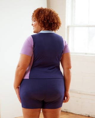 Person wearing a navy blue and pink outfit in a bright room.  This top is the Bonair Athletic Top sewing pattern from Cashmerette.