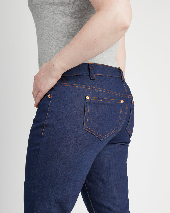Person wearing blue jeans on a plain background. These jeans are the Ames Jeans sewing pattern from Cashmerette.