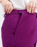 Purple pants with a white background. These pants are the Meriam Trousers sewing pattern from Cashmerette.
