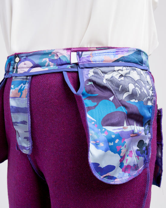 Purple pants worn inside out with colorful designs on a white background. These pants are the Meriam Trousers sewing pattern from Cashmerette.