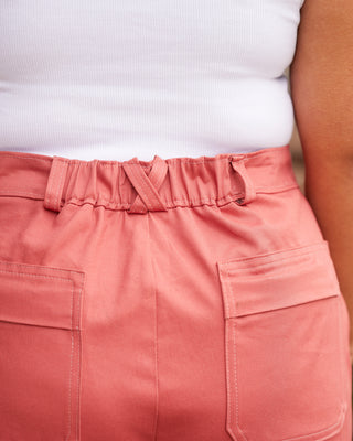 Close-up of pink pants with a white top underneath. These pants are the Esmond Cargo Pants sewing pattern from Cashmerette.