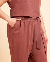 Brown sleeveless top and pants set on a beige background. These pants are the Everett Pants & Shorts sewing pattern from Cashmerette.
