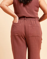 Person wearing a matching brown top and pants on a beige background. These pants are the Everett Pants & Shorts sewing pattern from Cashmerette.
