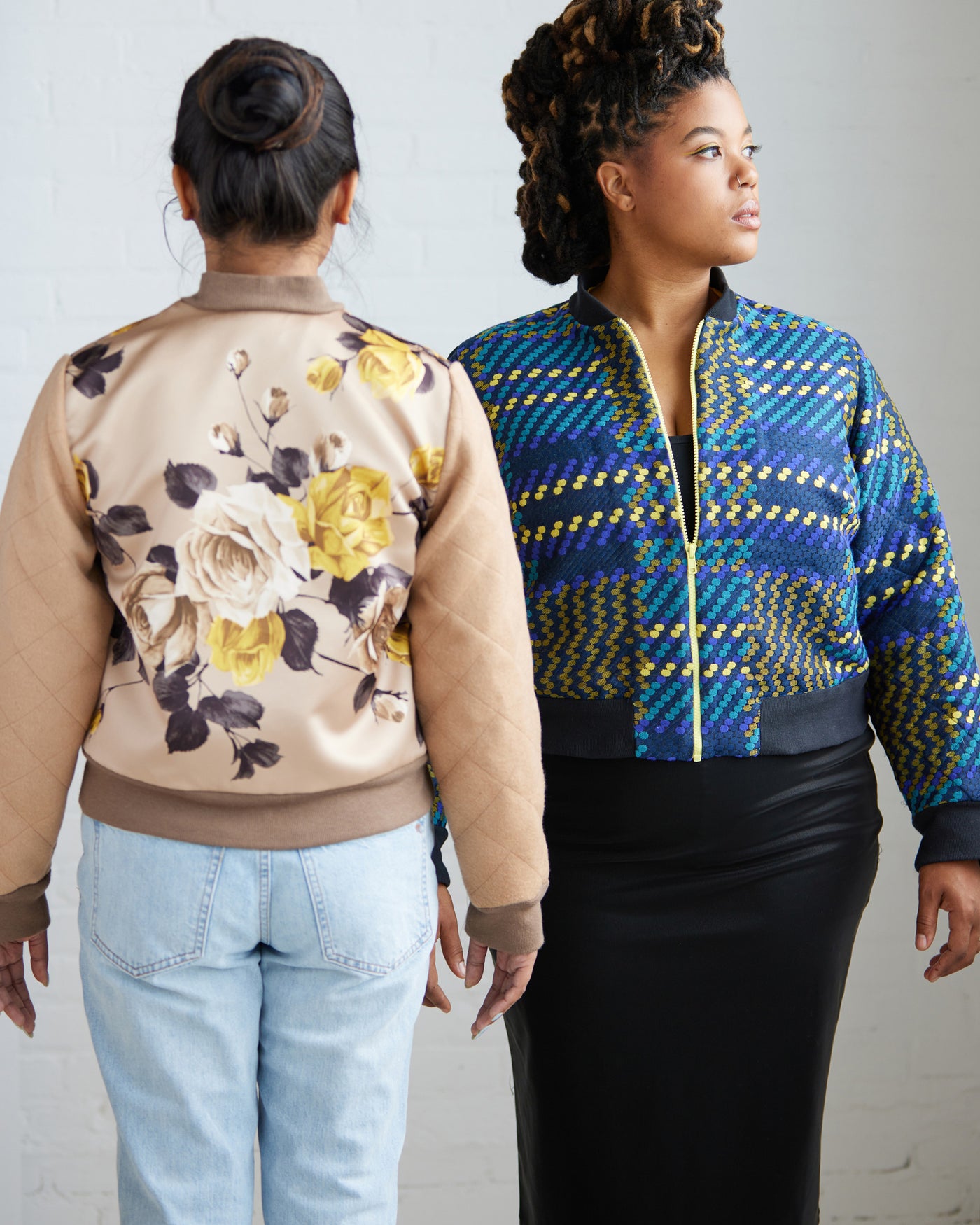 Two women wearing patterned jackets against a plain background. This jacket is the Cashmerette Club Kimball Bomber Jacket sewing pattern.