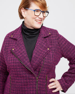 Woman wearing a purple coat with a plain background. This biker jacket is the Canton Moto Jacket sewing pattern from Cashmerette.